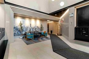 Woodside apartment for rent - the lobby of the building is spacious and has a large screen tv