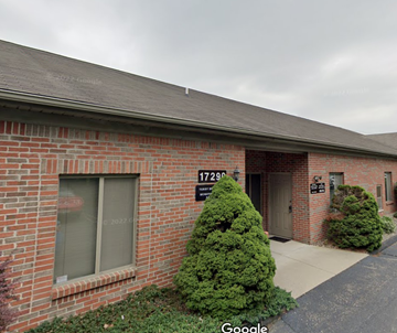 Livonia apartment for rent - the front of a brick building with a porch and a driveway