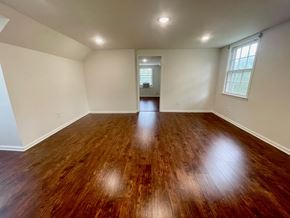 Louisville house for rent - A room with wooden flooring and a window on the right side.