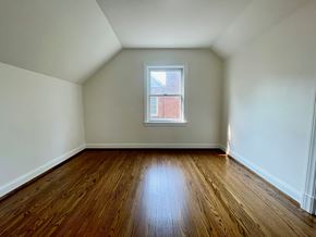 Louisville house for rent - A room with wooden floors and a window.