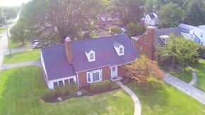 Louisville house for rent - A red brick house with a white door and windows.