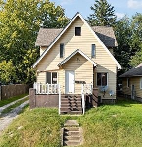 Akron apartment for rent - A small house with a porch and a satellite dish on the roof.