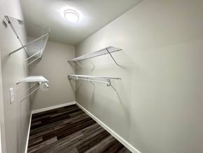 Fountain Inn house for rent - a spacious walk in closet with shelves and hanging racks