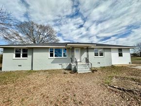Fountain Inn house for rent - a white house with a yard and a cloudy sky