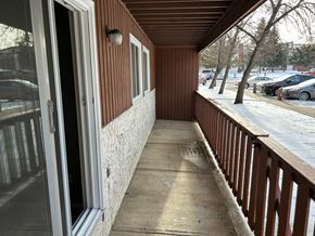 Prince Albert house for rent - a porch outside of a building with a snow covered sidewalk
