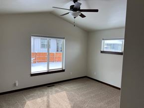 Bozeman house for rent - a living room with a ceiling fan and a window