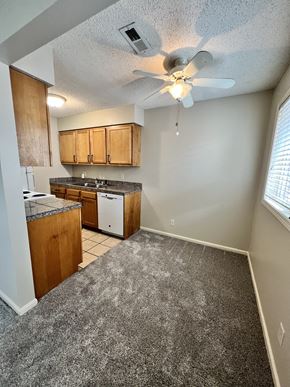 Lincoln apartment for rent - an empty kitchen with a ceiling fan and