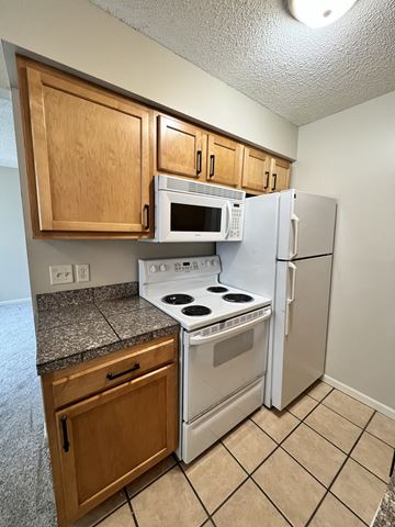 Lincoln apartment for rent - a kitchen with a stove microwave and refrigerator