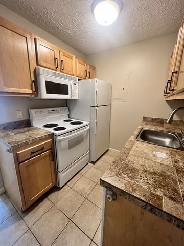 Lincoln apartment for rent - a kitchen with a stove microwave and refrigerator