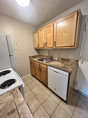 Lincoln apartment for rent - a kitchen with a stove refrigerator and sink