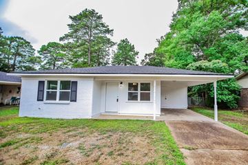 New Llano house for rent - the front of a white house with a yard and trees