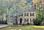 Cary house for rent - A house with a blue roof and a white garage door.