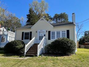 Raleigh house for rent - a white house with a porch and a white staircase