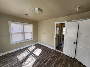 Harrah house for rent - an empty room with a window and a door