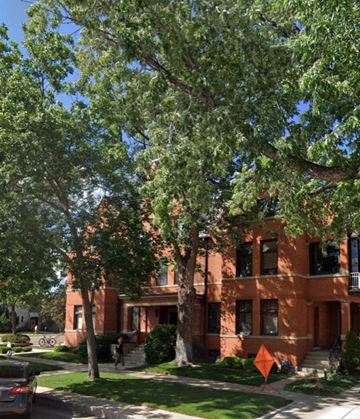 Colorado Springs apartment for rent - a red brick building with trees in front of it