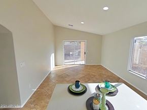 Buckeye house for rent - an empty living room with a dining room table and a patio door