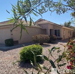 Buckeye house for rent - a house with a yard and bushes in front of it