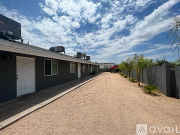 Phoenix apartment for rent - a long dirt road in front of a house with a cloudy sky