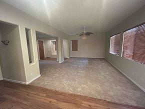 Buckeye house for rent - an empty living room with a ceiling fan