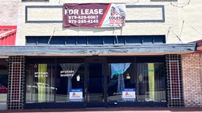 Bay City house for rent - the front of a store with afor lease sign