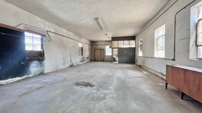 Bay City house for rent - an empty room with a desk and a blackboard