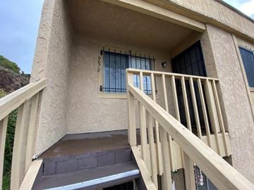 San Diego apartment for rent - a porch of a building with a staircase and a window