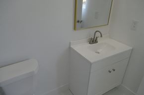 Lehigh Acres house for rent - a bathroom with a sink and a mirror and a toilet