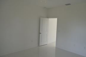 Lehigh Acres house for rent - an empty room with a door and a white wall