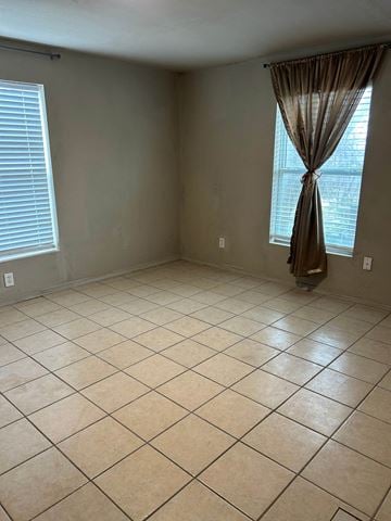 Killeen house for rent - an empty living room with tiled floors and a window
