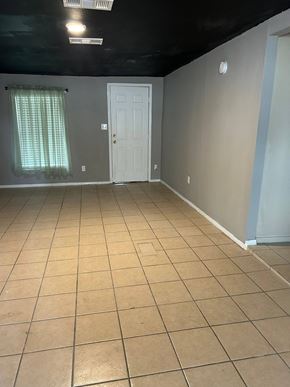 Killeen house for rent - an empty room with a tiled floor and a white door