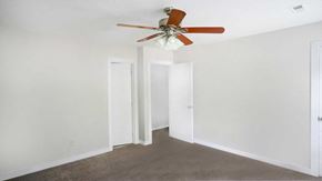 Raleigh house for rent - A room with a ceiling fan and three white doors.