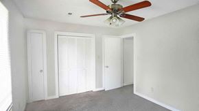 Raleigh house for rent - A room with a ceiling fan and three doors.