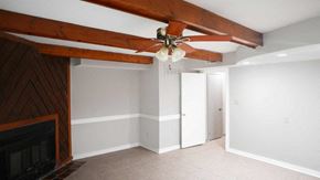 Raleigh house for rent - A room with a fireplace and a chandelier.