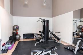Vancouver apartment for rent - A gym with a variety of equipment including weights and a bench.