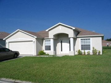 Fort Myers house for rent - A house with a car parked in front.