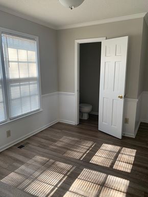 Raleigh house for rent - A room with a toilet and a door.