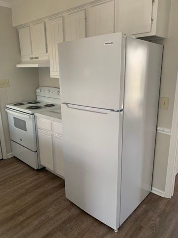 Raleigh house for rent - A white fridge and stove in a kitchen.