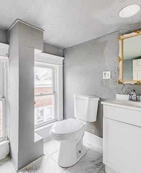 Akron apartment for rent - a bathroom with a toilet and a sink and a window