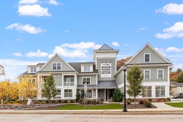 Norfolk apartment for rent - A large, two-story building with a sign that reads "Estate Agents" in front of it.