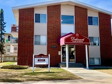 Edmonton apartment for rent - A Deloway apartment building with a sign in front.