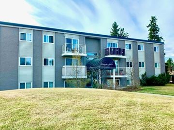 Edmonton apartment for rent - Apartment building with a balcony on the second floor.