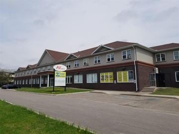 Sault Ste. Marie apartment for rent - A building with a sign that says "ALL AV" in front of it.