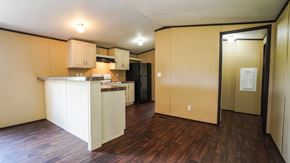 Royse City apartment for rent - A kitchen with wooden floors and beige walls.