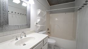 Royse City apartment for rent - A white bathroom with a sink, toilet, and bathtub.