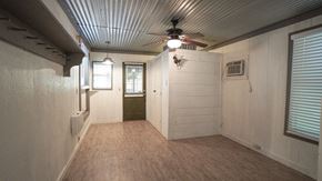 Royse City apartment for rent - A room with a ceiling fan and a window with blinds.
