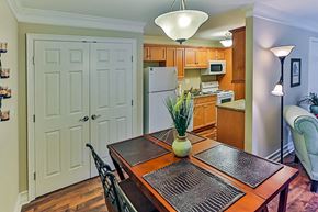 Raleigh apartment for rent - A kitchen with a table and chairs in the foreground.
