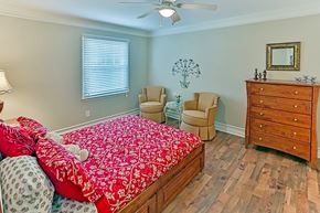 Raleigh apartment for rent - A bedroom with a bed, chair, and dresser.