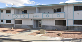 Las Vegas apartment for rent - an old building with a blue and white facade and a sidewalk