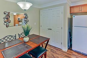 Raleigh apartment for rent - A kitchen with a table and chairs and a fridge.