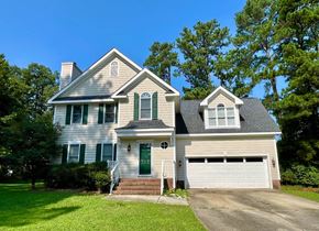 Apex house for rent - a white house with a green door and a lawn
